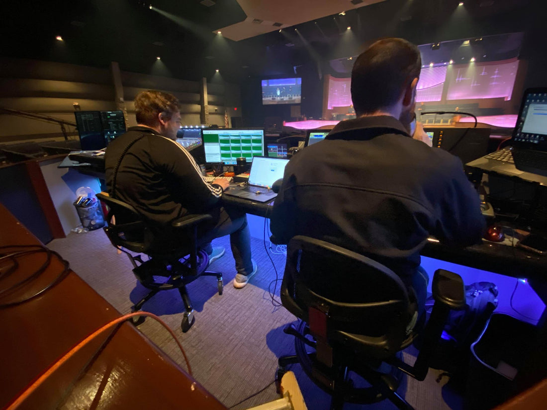 Church sound booth with engineers at the mixing console