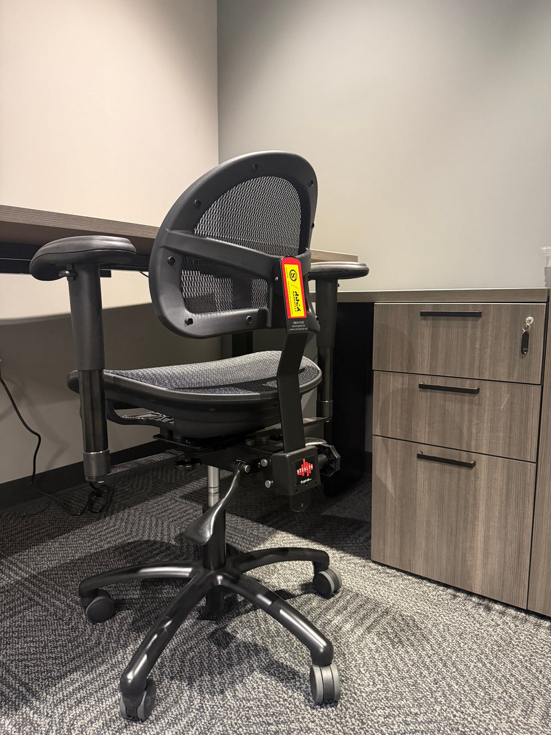 Stealth chair with footring set at standing-desk height