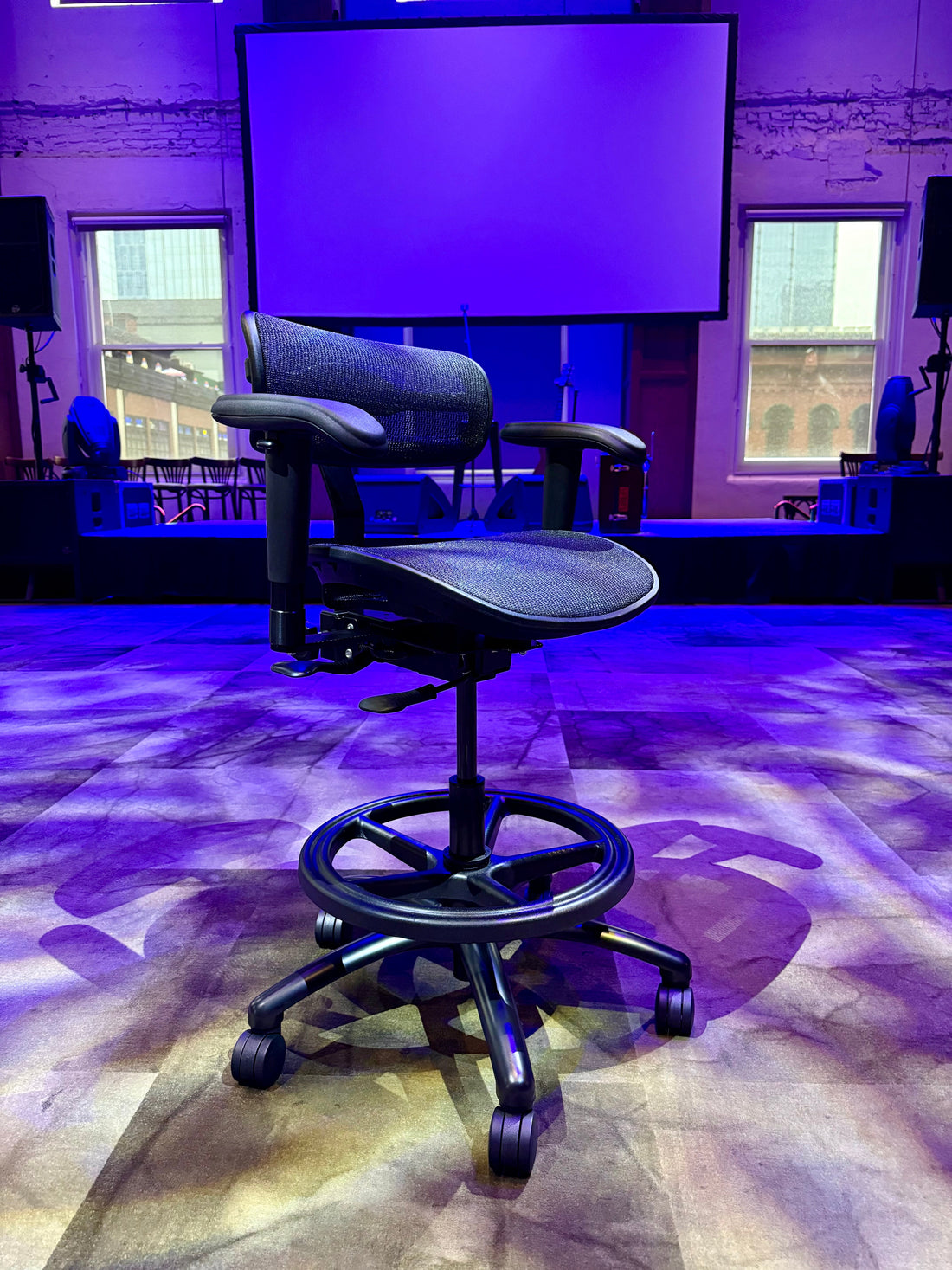 Stealth chair in a studio lit with purple light, ready for a streaming setup