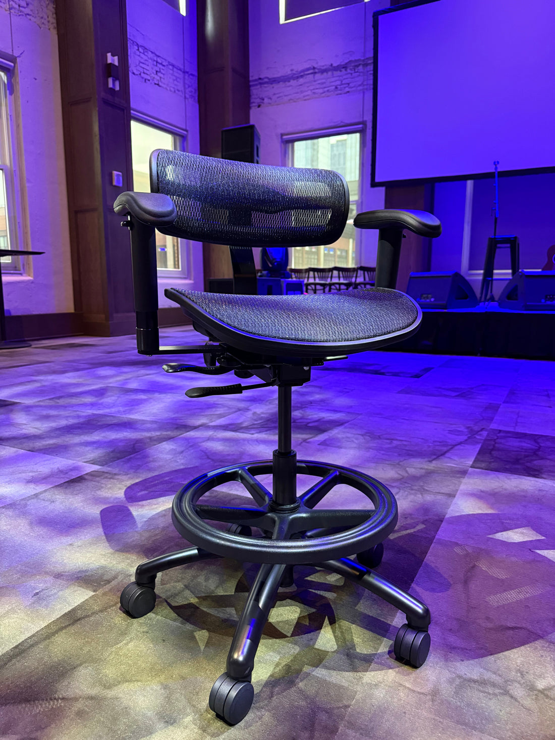 Stealth chair with padded arms and footring, side view