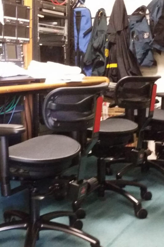Stealth chairs at the desk of a podcast studio